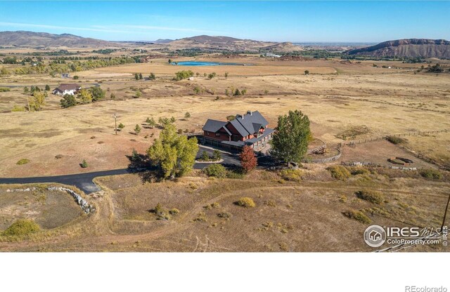 drone / aerial view featuring a mountain view and a rural view