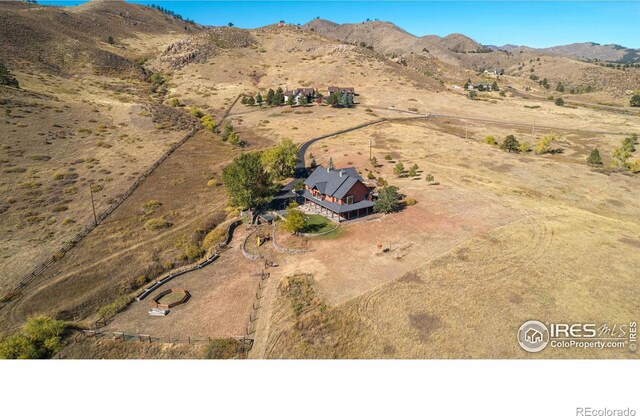 drone / aerial view featuring a rural view and a mountain view