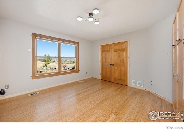 unfurnished room with light hardwood / wood-style floors