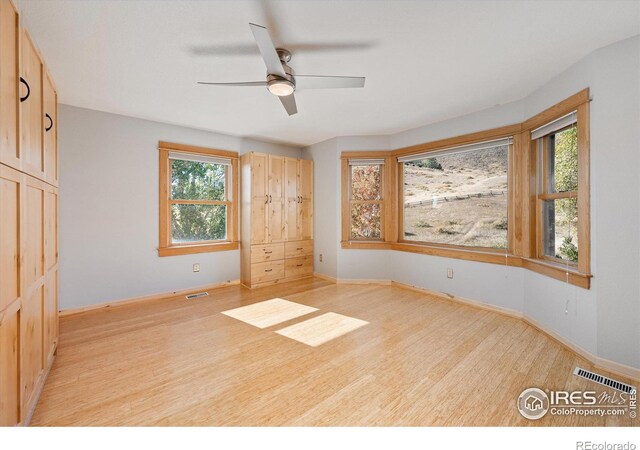 spare room featuring ceiling fan and light wood-type flooring