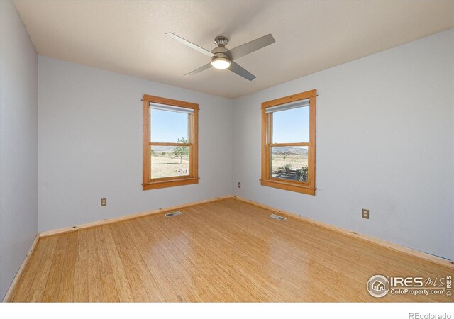 spare room with ceiling fan and light hardwood / wood-style flooring