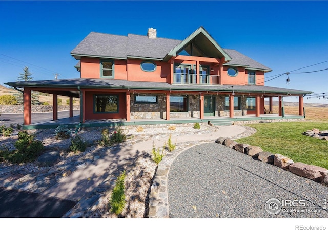 view of front of property with a front lawn and a balcony