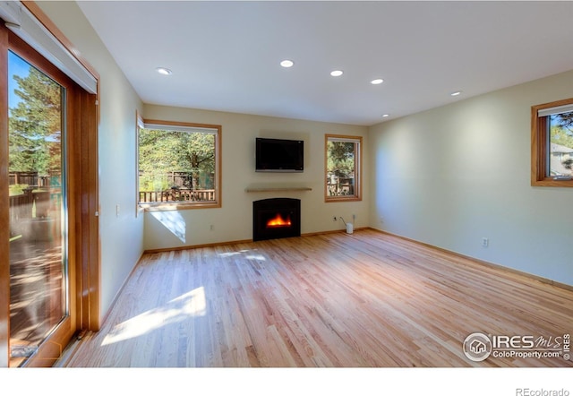 unfurnished living room with light hardwood / wood-style flooring