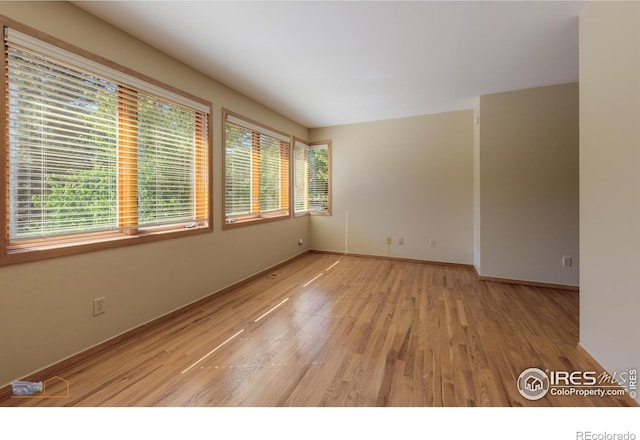 spare room featuring light hardwood / wood-style floors