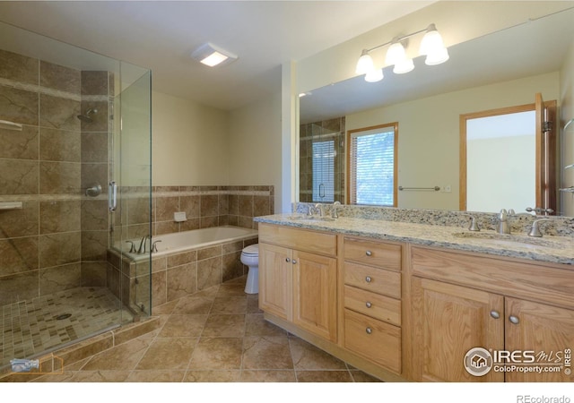 full bathroom with tile patterned flooring, toilet, vanity, and separate shower and tub