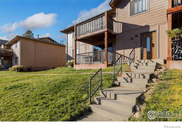 1155 S Saint Vrain Ave Unit U6, Estes Park, CO 80517 - view of grassy yard with a balcony