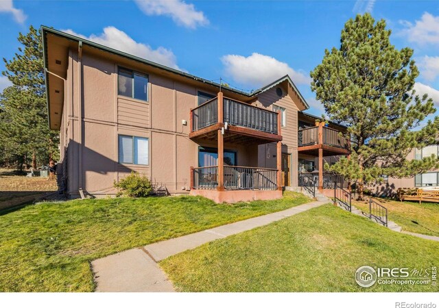 1155 S Saint Vrain Ave Unit U6, Estes Park, CO 80517 - rear view of property featuring stucco siding and a lawn
