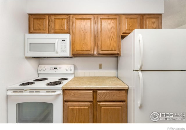 1155 S Saint Vrain Ave Unit U6, Estes Park, CO 80517 - kitchen with white appliances, light countertops, and brown cabinets