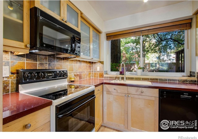 kitchen with light brown cabinetry, sink, tasteful backsplash, and black appliances