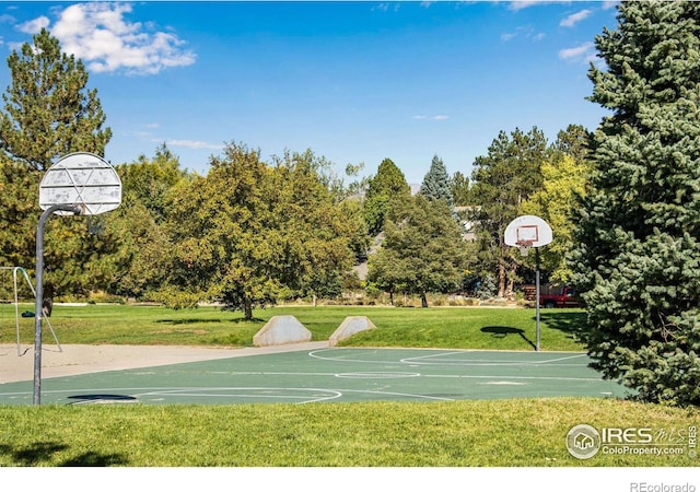 view of sport court featuring a yard