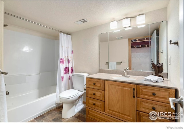 full bathroom with toilet, shower / bath combo, vanity, and a textured ceiling