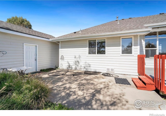 back of property with a patio