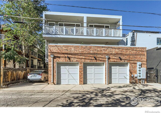 view of front facade featuring a balcony and a garage