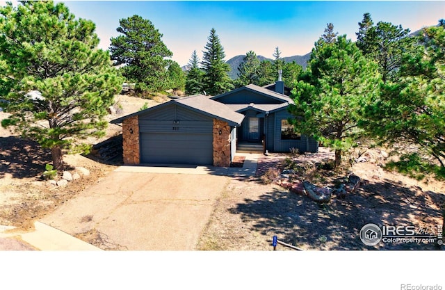 view of front of property featuring a garage and a mountain view