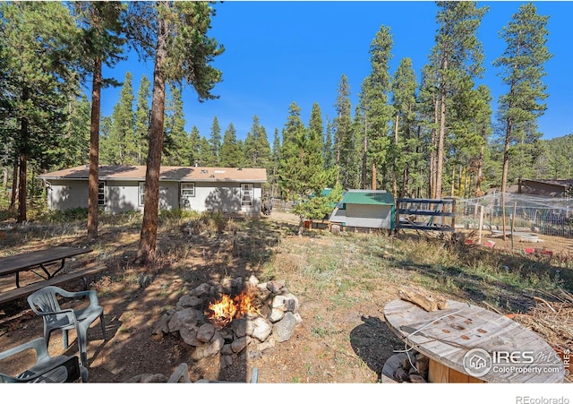 view of yard with a fire pit