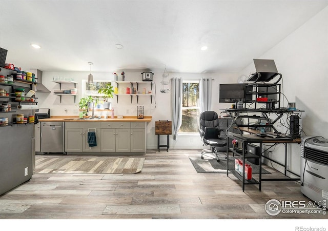 kitchen with stainless steel dishwasher, light wood-type flooring, butcher block countertops, gray cabinets, and open shelves