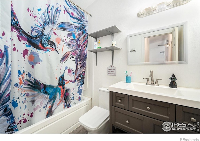 bathroom featuring shower / bath combo, vanity, and toilet