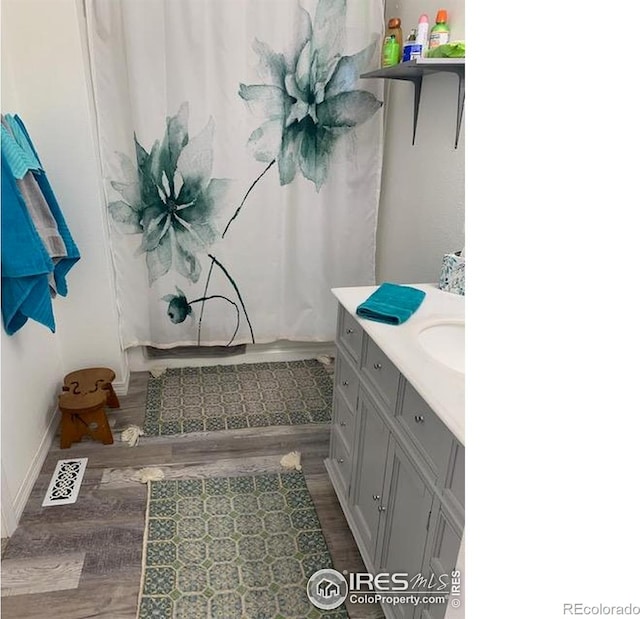 272 Severance Lodge Rd, Black Hawk, CO 80422 - full bath with wood finished floors and vanity