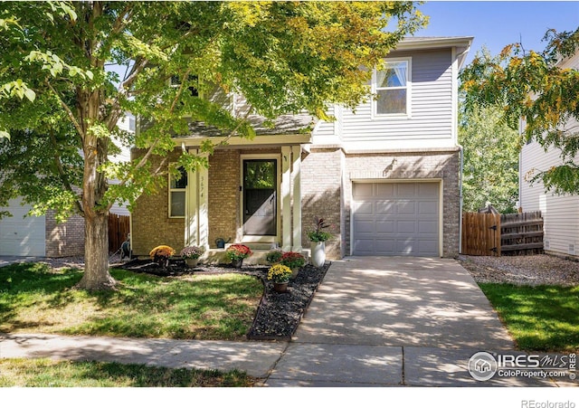 3674 Dexter St, Denver, CO 80207 - view of front facade with a garage, brick siding, and driveway
