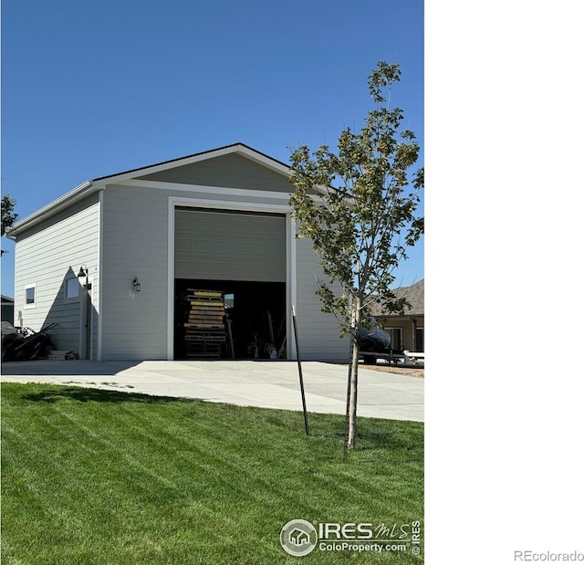 exterior space featuring a garage and a front lawn