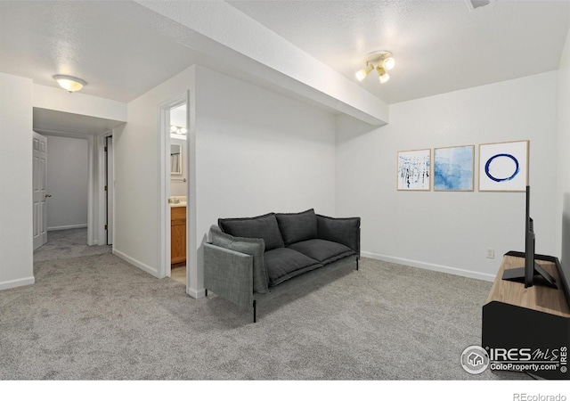 carpeted living room with a textured ceiling