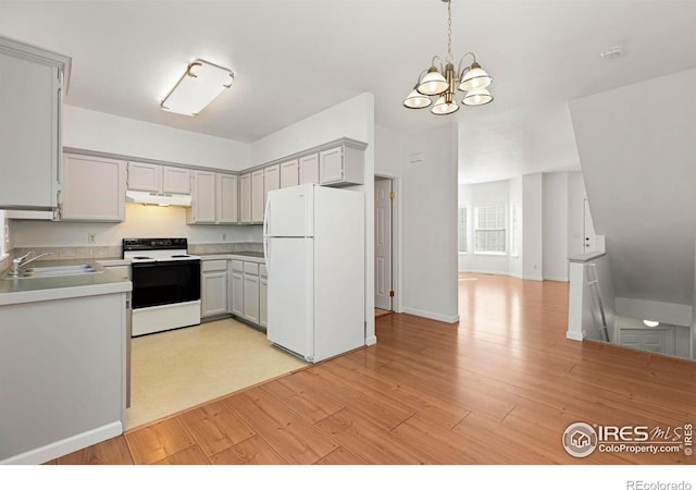 kitchen featuring sink, a chandelier, decorative light fixtures, white appliances, and light wood-type flooring