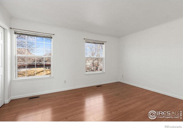 empty room with hardwood / wood-style floors