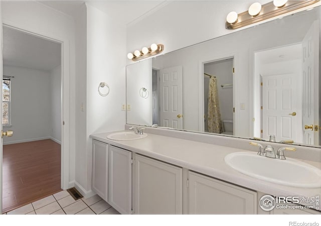 bathroom featuring wood-type flooring, vanity, toilet, and crown molding