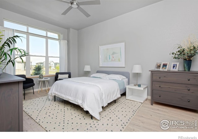 bedroom with ceiling fan and light hardwood / wood-style flooring