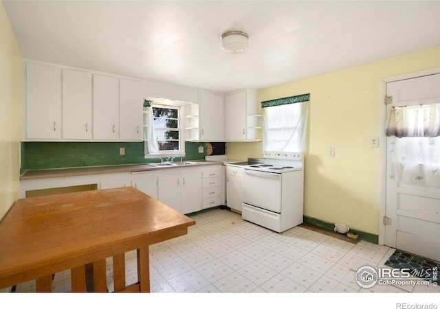 kitchen with decorative backsplash, white cabinets, white electric range oven, and sink