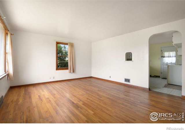 unfurnished room with hardwood / wood-style floors