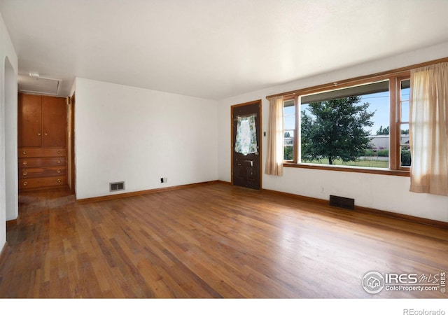 empty room with dark wood-type flooring