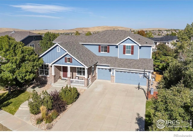 view of front of home featuring covered porch and a garage