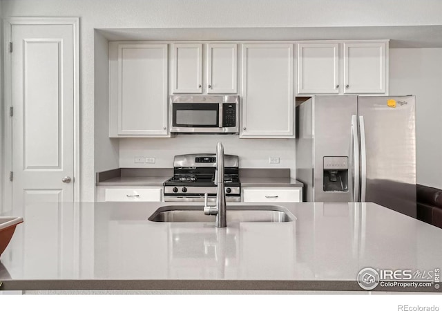 kitchen with stainless steel appliances and white cabinets