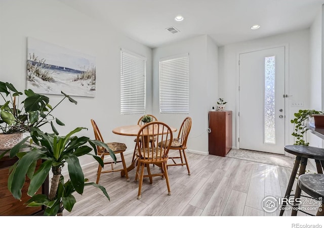 dining space featuring plenty of natural light and light hardwood / wood-style floors