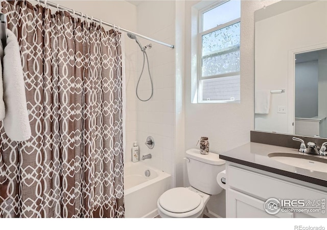 full bathroom with vanity, toilet, and shower / tub combo with curtain