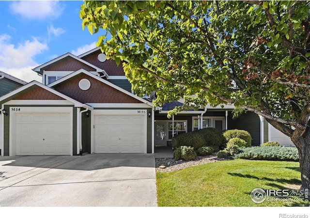 view of front of property featuring a garage and a front yard