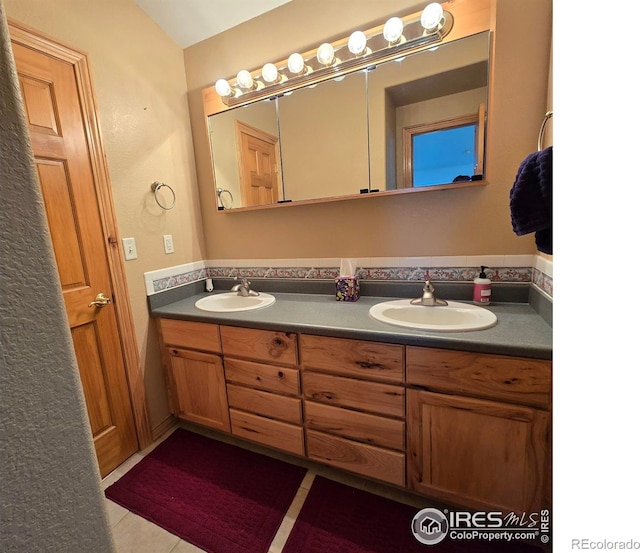 bathroom with vanity and tile patterned flooring