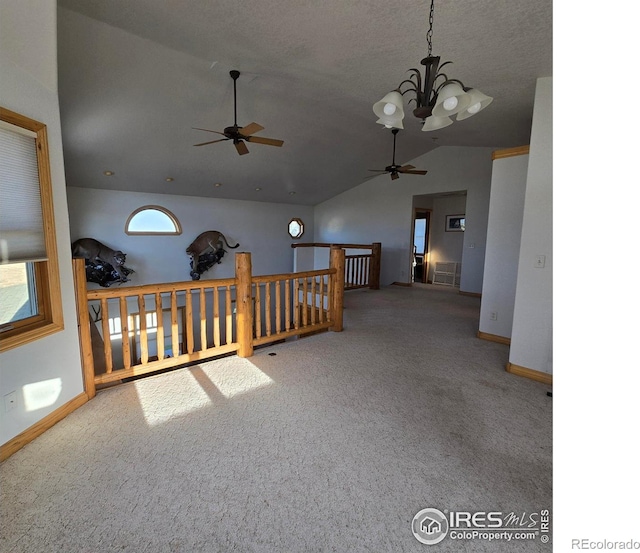 unfurnished room featuring carpet, vaulted ceiling, and a notable chandelier