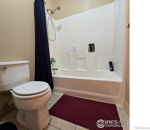 bathroom with toilet, tile patterned floors, and shower / tub combo with curtain