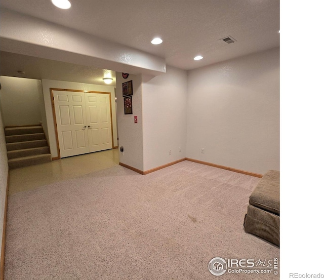 basement featuring a textured ceiling