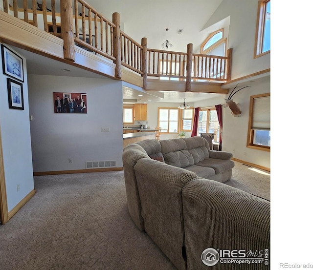 carpeted living room featuring a high ceiling