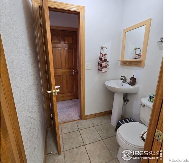 bathroom featuring toilet and tile patterned flooring