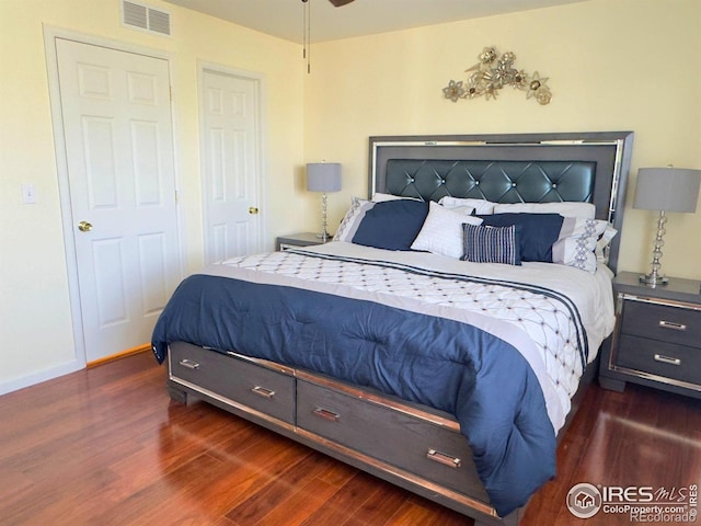 bedroom with dark hardwood / wood-style floors