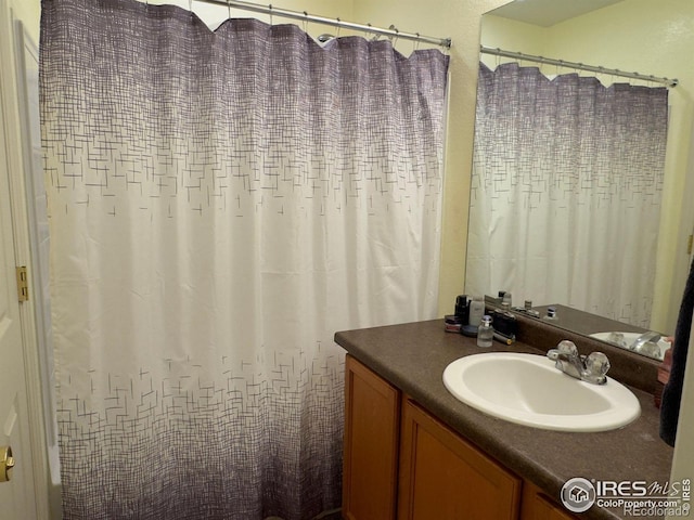 bathroom featuring vanity and a shower with shower curtain