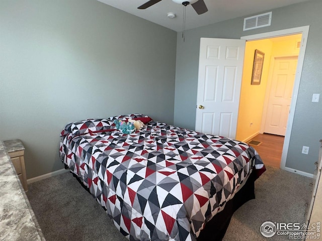 bedroom featuring lofted ceiling, dark colored carpet, and ceiling fan