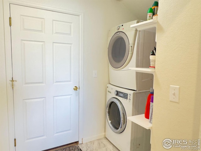 laundry room with stacked washing maching and dryer