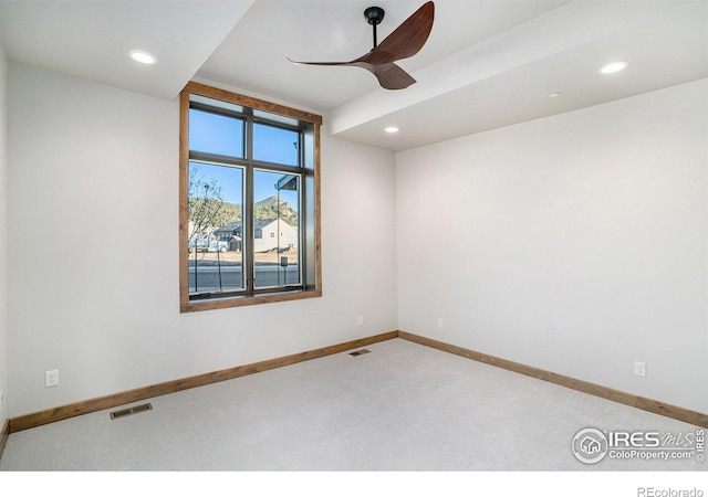 spare room featuring carpet floors and ceiling fan