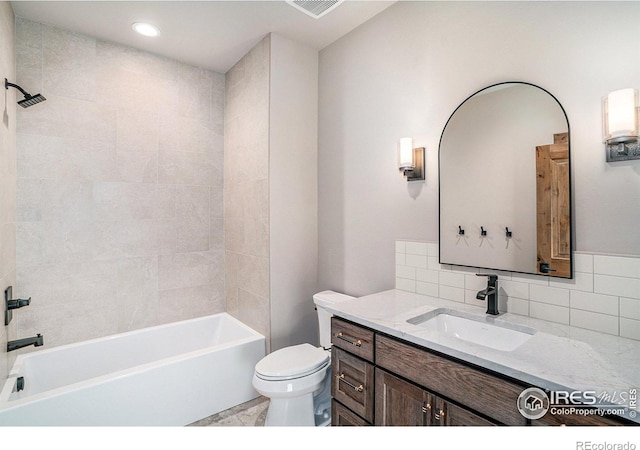 full bathroom with tiled shower / bath combo, backsplash, vanity, and toilet