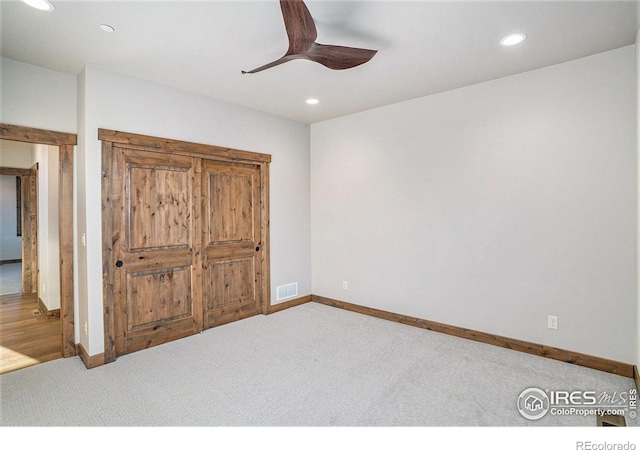 unfurnished bedroom with carpet floors and ceiling fan